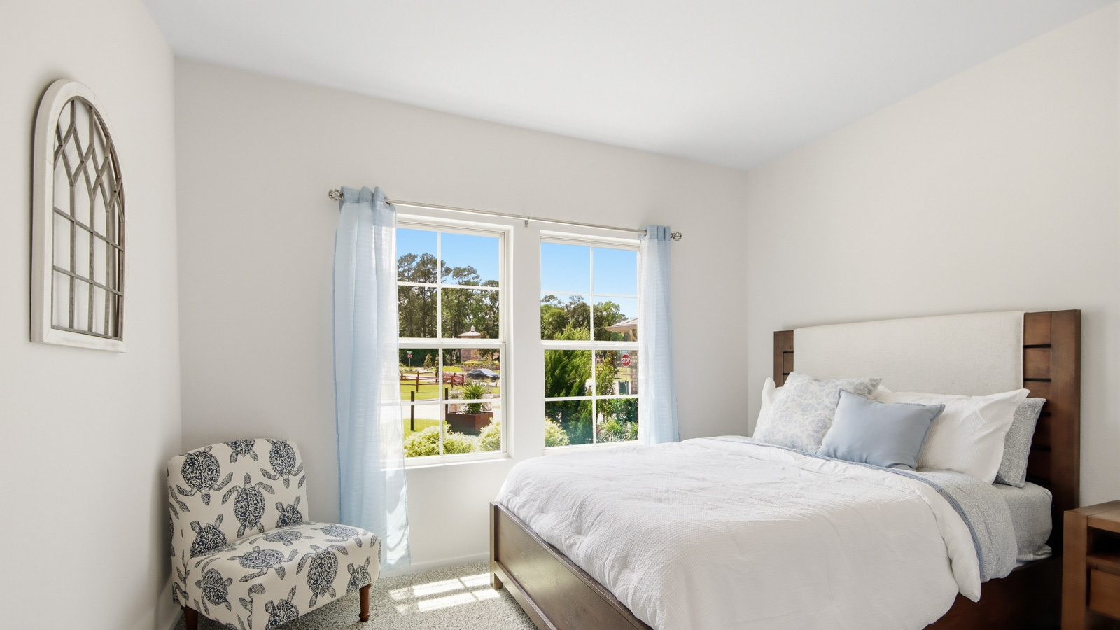 Secondary bedroom with shag carpet flooring and bright window