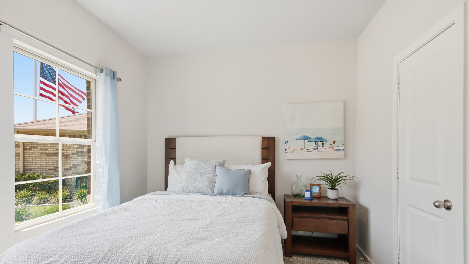 Secondary bedroom with shag carpet flooring and bright window