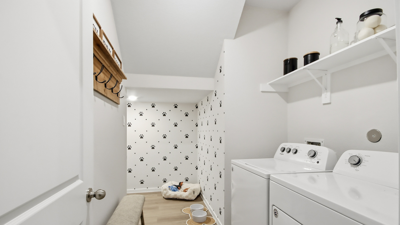 Utility room with storage located off the entry hallway and garage door