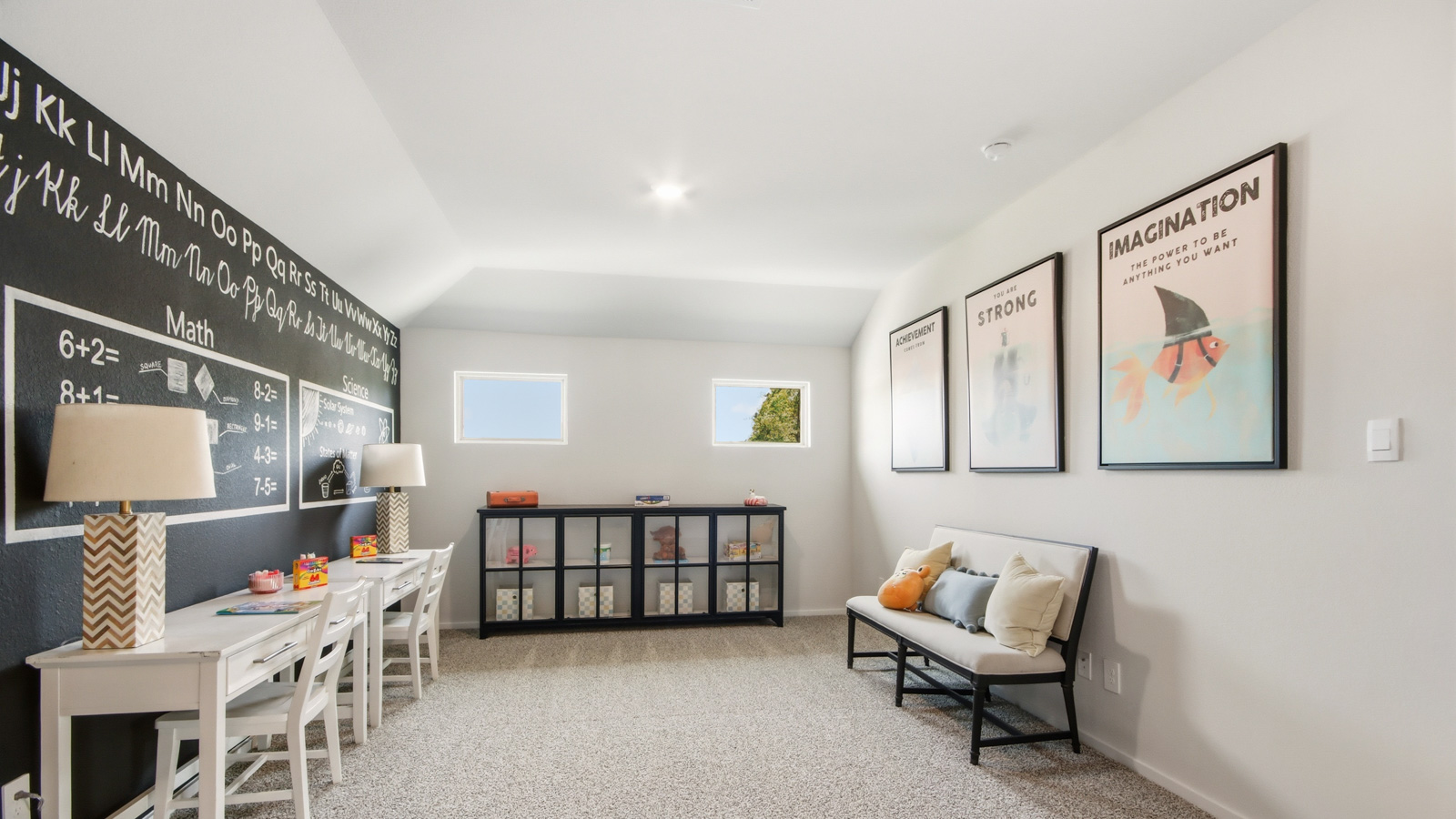 Second story game room with carpet flooring with bright windows in this multi functional space in Willis TX