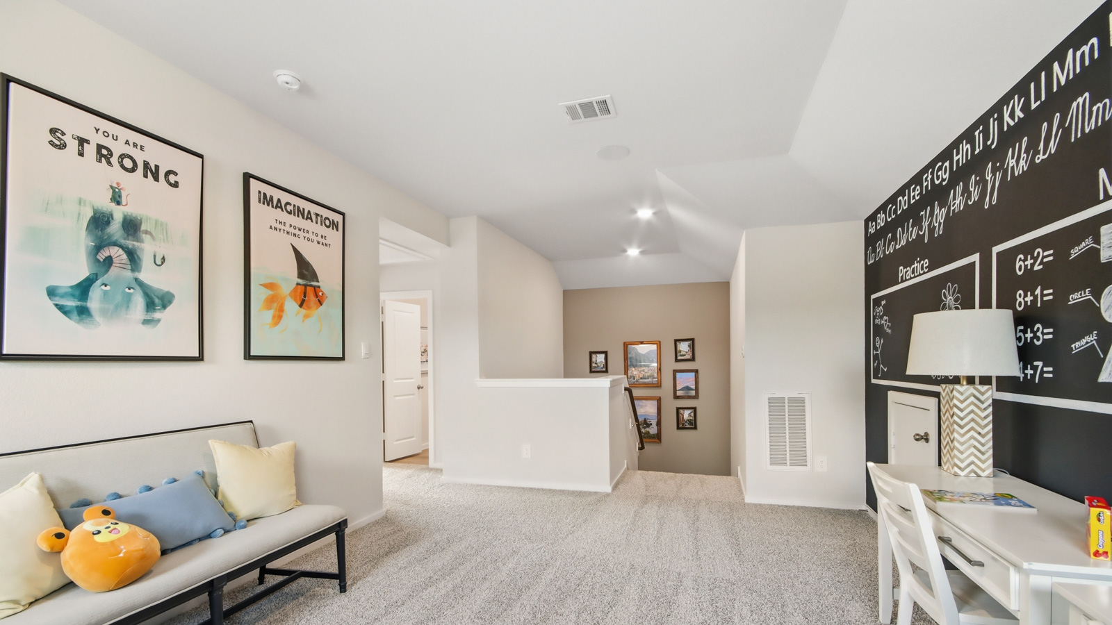 Second story game room with carpet flooring with bright windows in this multi functional space in Willis TX