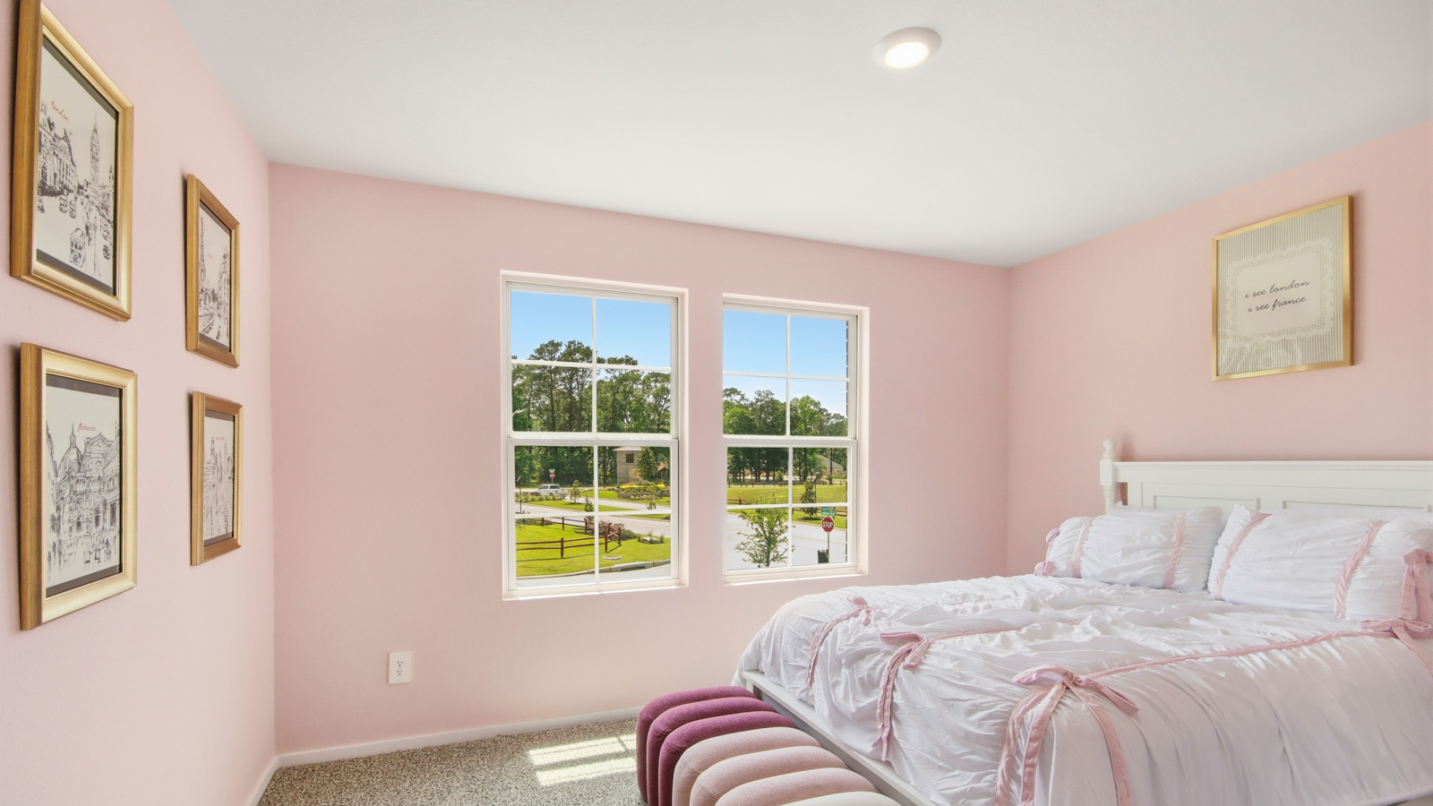Second level secondary bedroom with carpet flooring and bright window