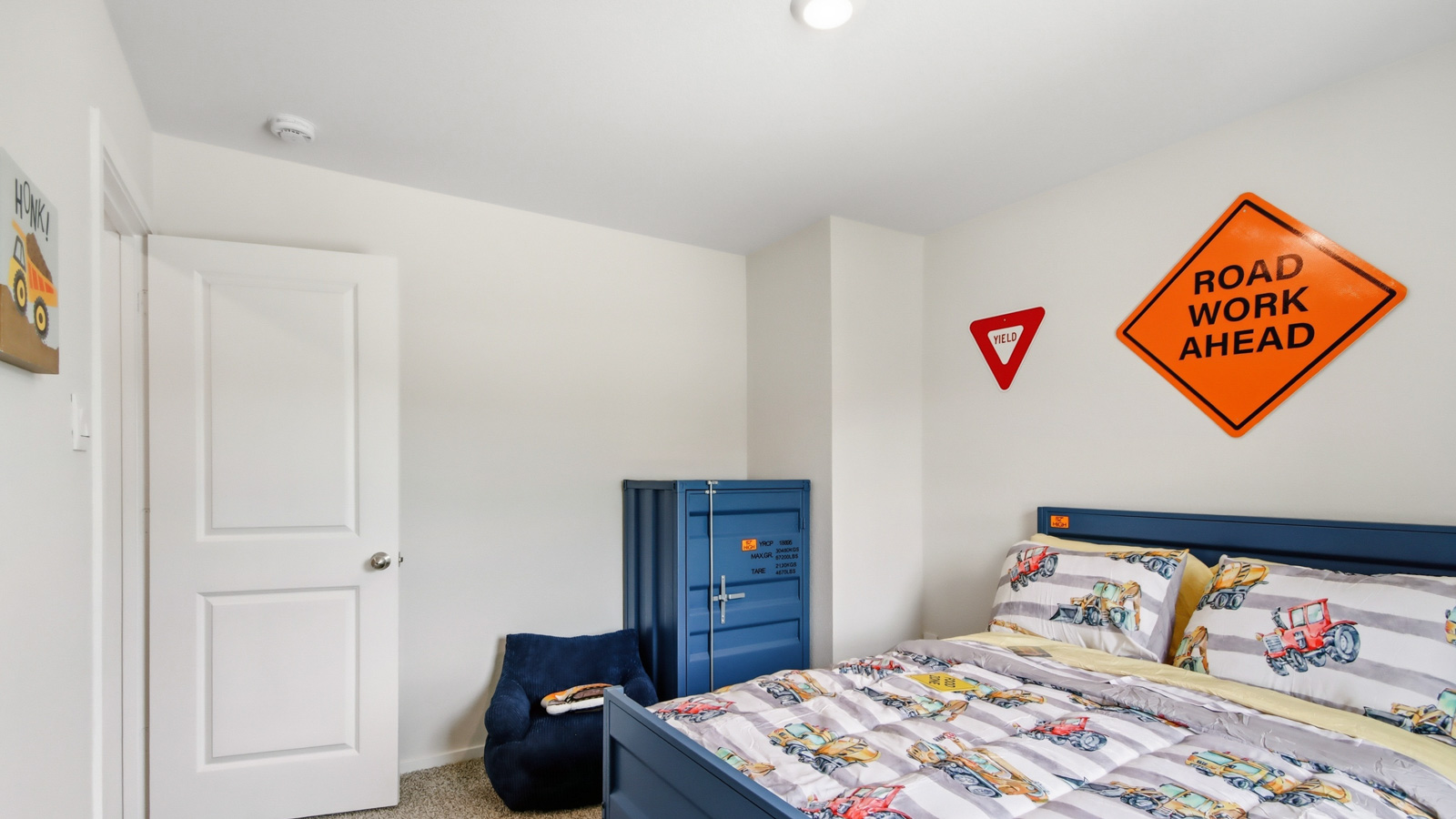 Second level secondary bedroom with carpet flooring and bright window