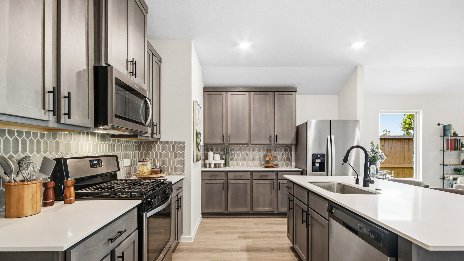 Kitchen with quartz countertops and an island and vinyl floor