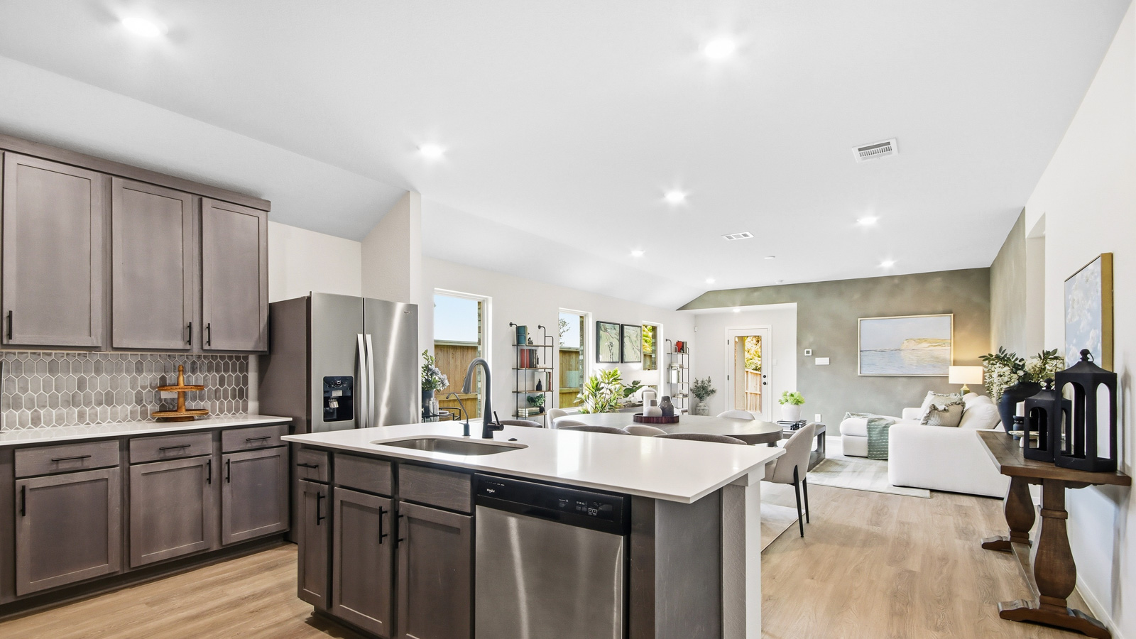 Kitchen with quartz countertops and an island and vinyl floor