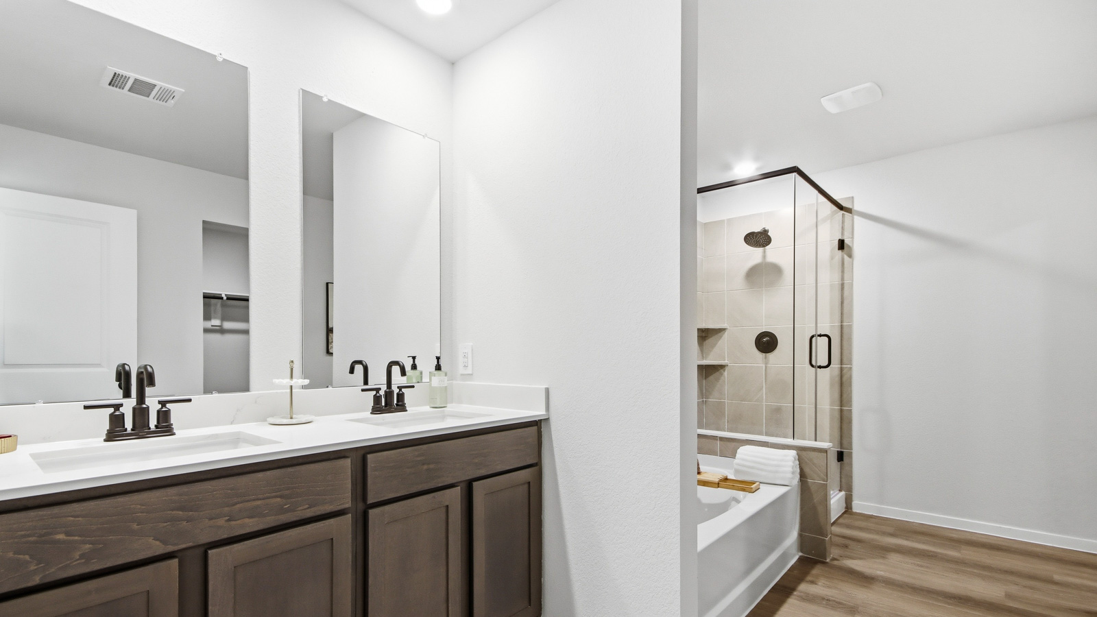Primary bathroom with soaker tub and tile shower with semi frameless glass in Willis TX
