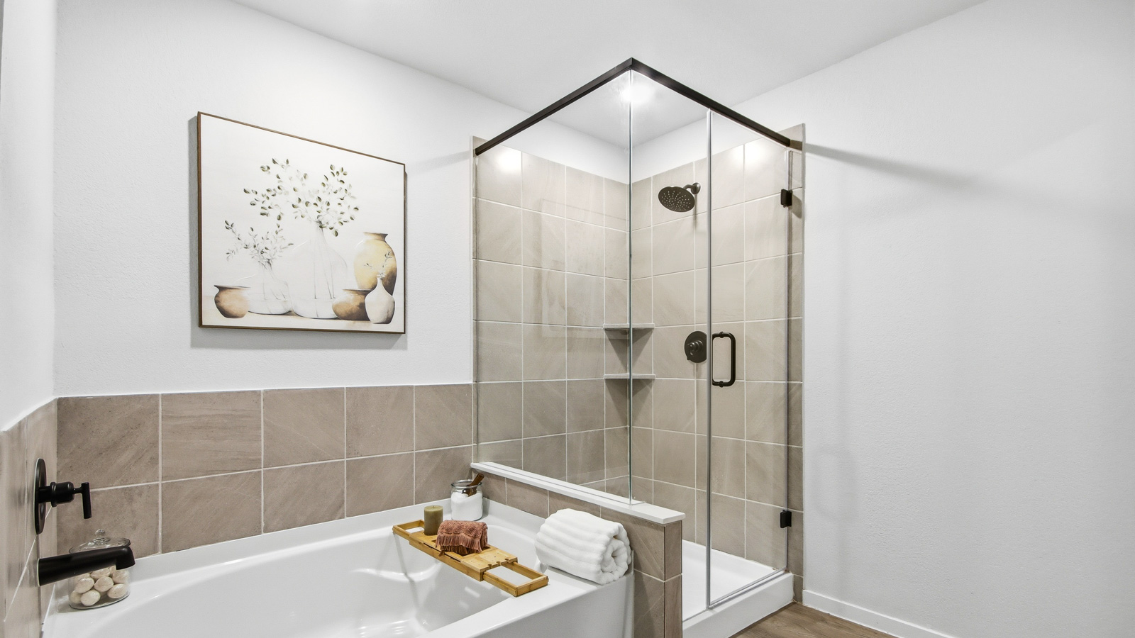 Primary bathroom with soaker tub and tile shower with semi frameless glass in Willis TX