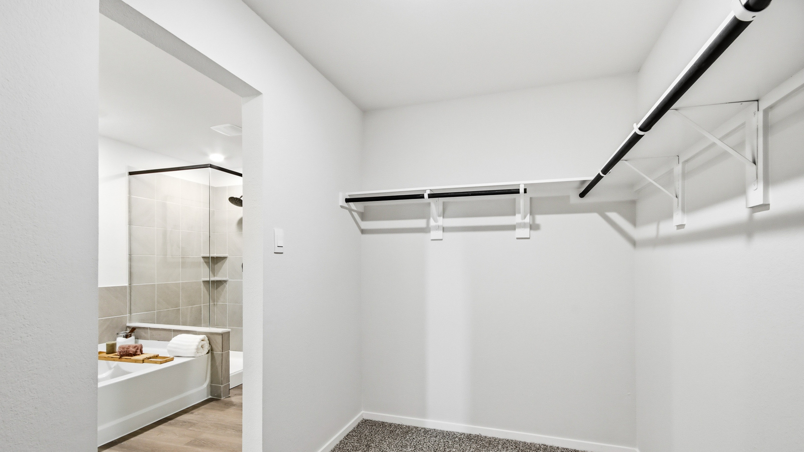 Primary bedroom walk-in closet with carpet flooring in Lexington Heights community in Willis TX