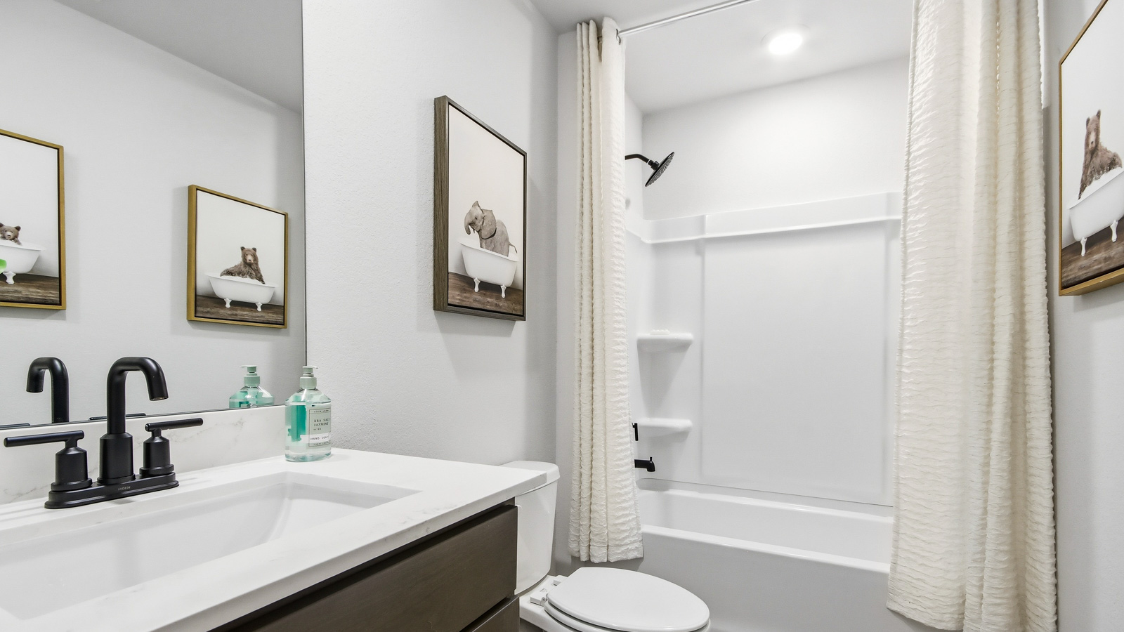 Secondary bathroom with tub/shower combo with quartz counter tops in Willis TX