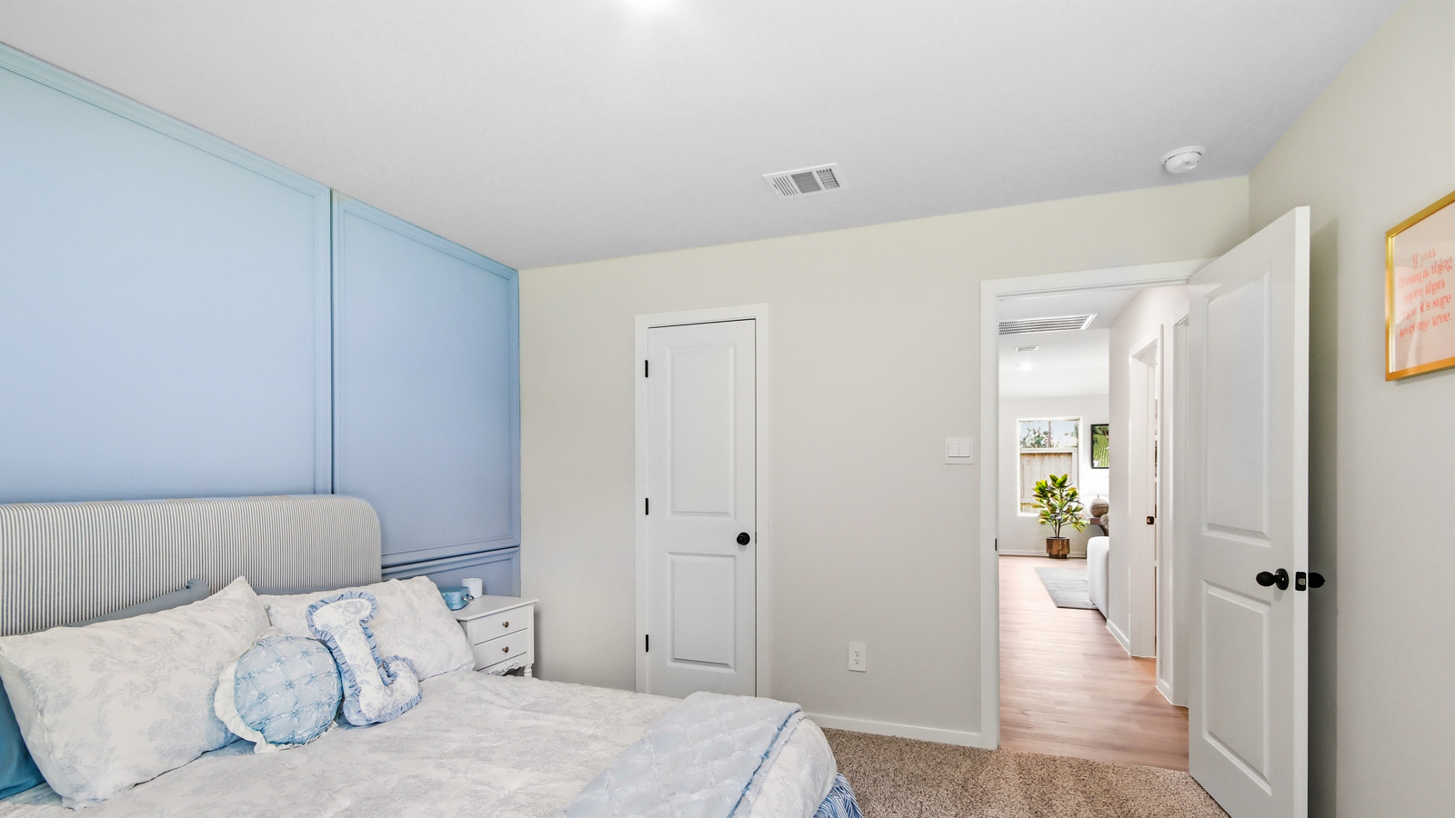 Secondary bedroom with shag carpet flooring and bright window