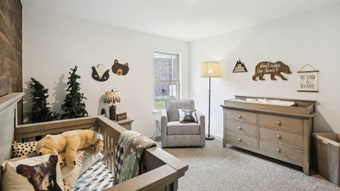 Secondary bedroom with windows, white walls, and light carpet.