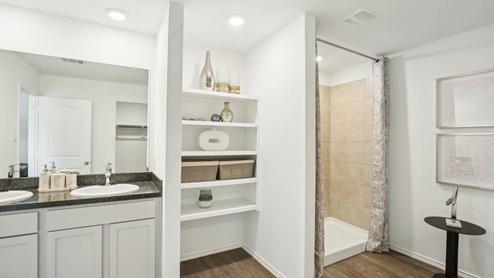 Laundry room with white walls and vinyl wood flooring.