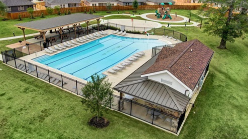 Amenity center with a pool, splash pad, and playground.