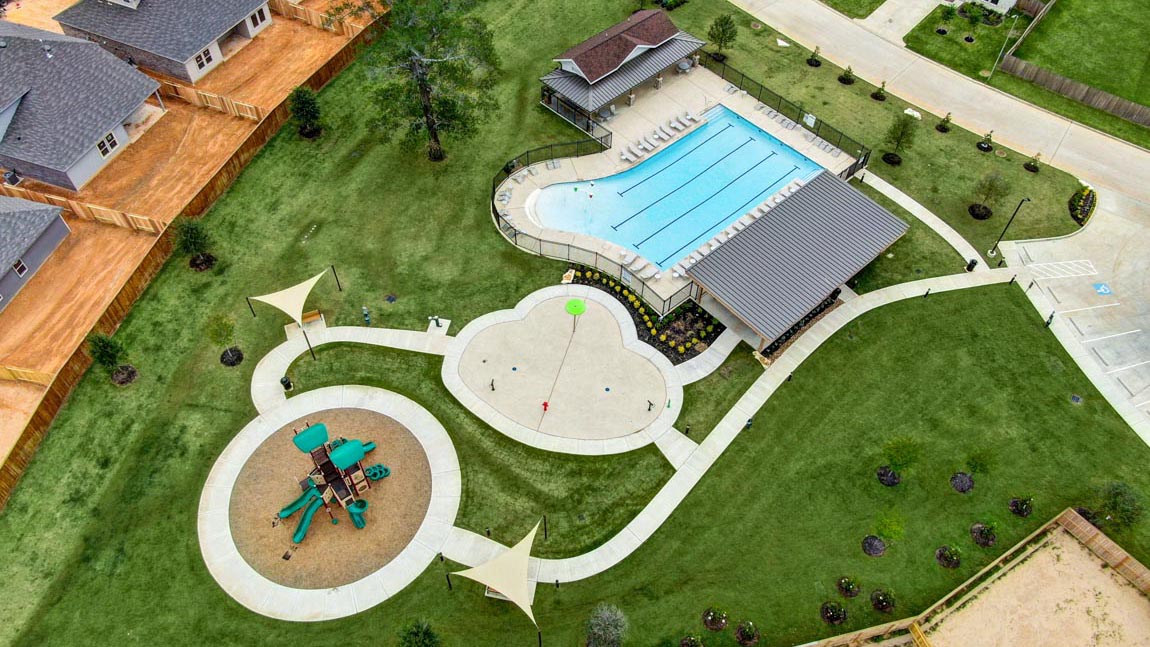 amenities in Mill Creek community located in Magnolia TX. Pool and park and picnic benches and playground