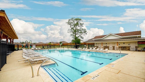 Amenity center with a pool, splash pad, and playground.