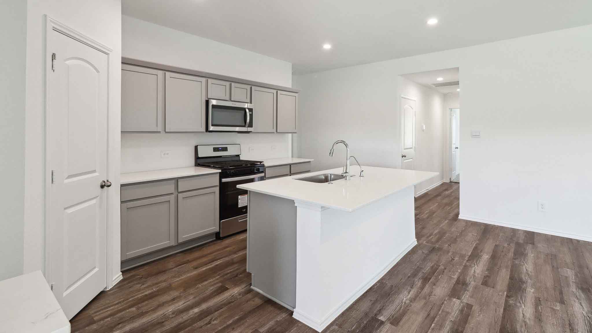 Kitchen with island and stainless-steel appliances.