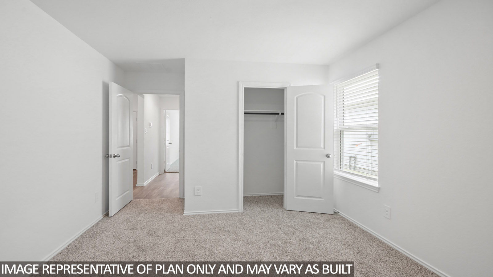 Secondary bedroom with carpet flooring