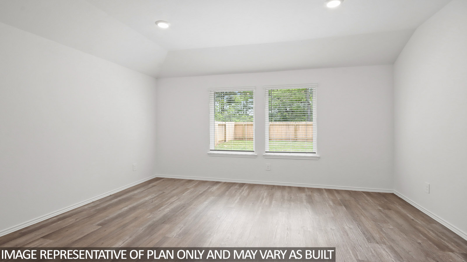 Spacious living area with vinyl flooring