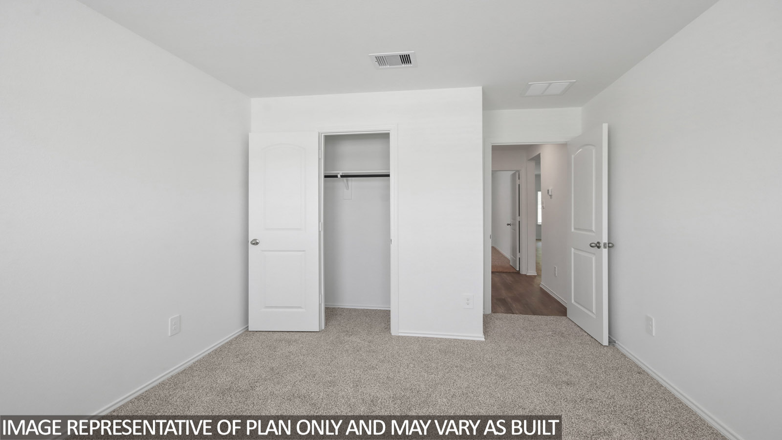 Secondary bedroom with carpet flooring