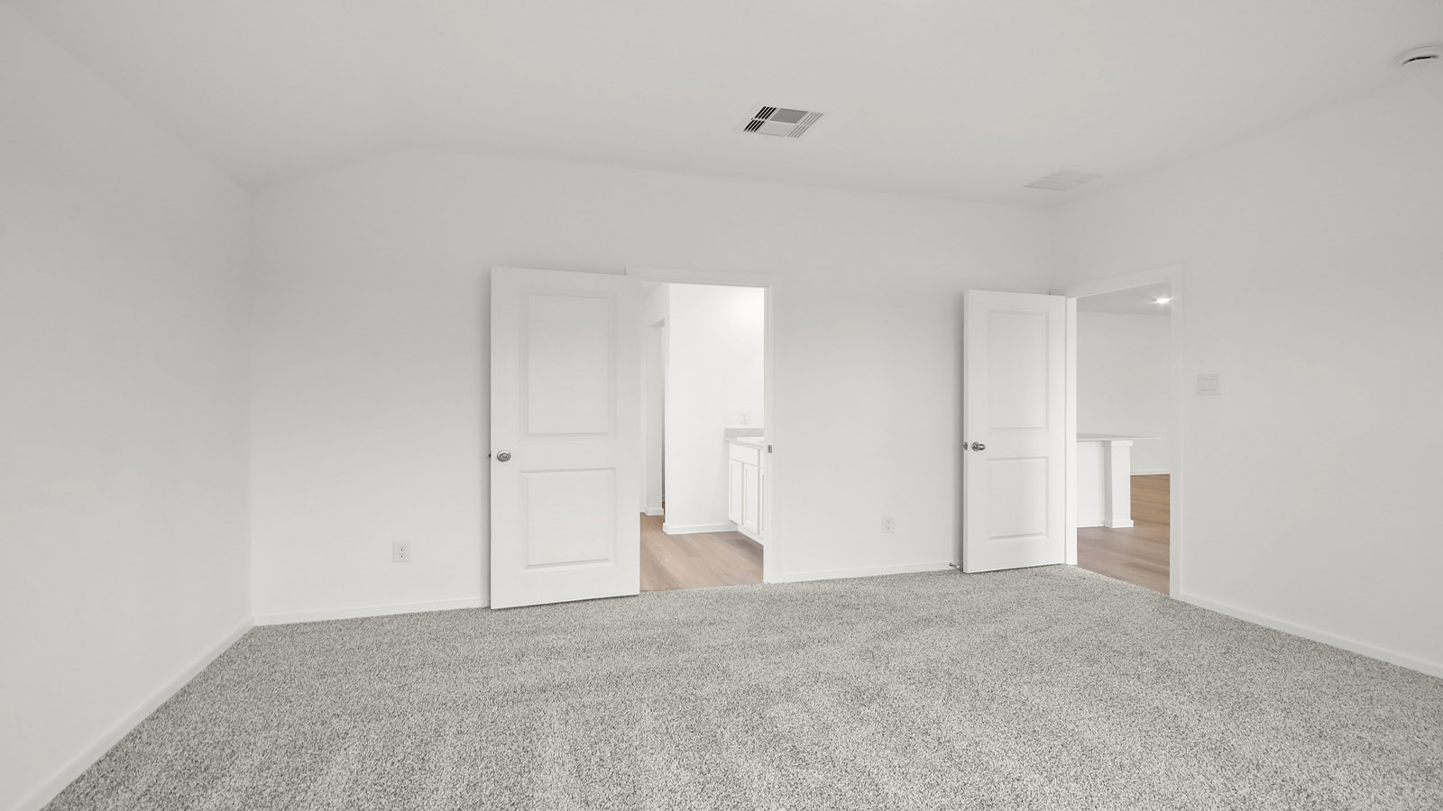 Large Primary bedroom with shag carpet flooring and bright window