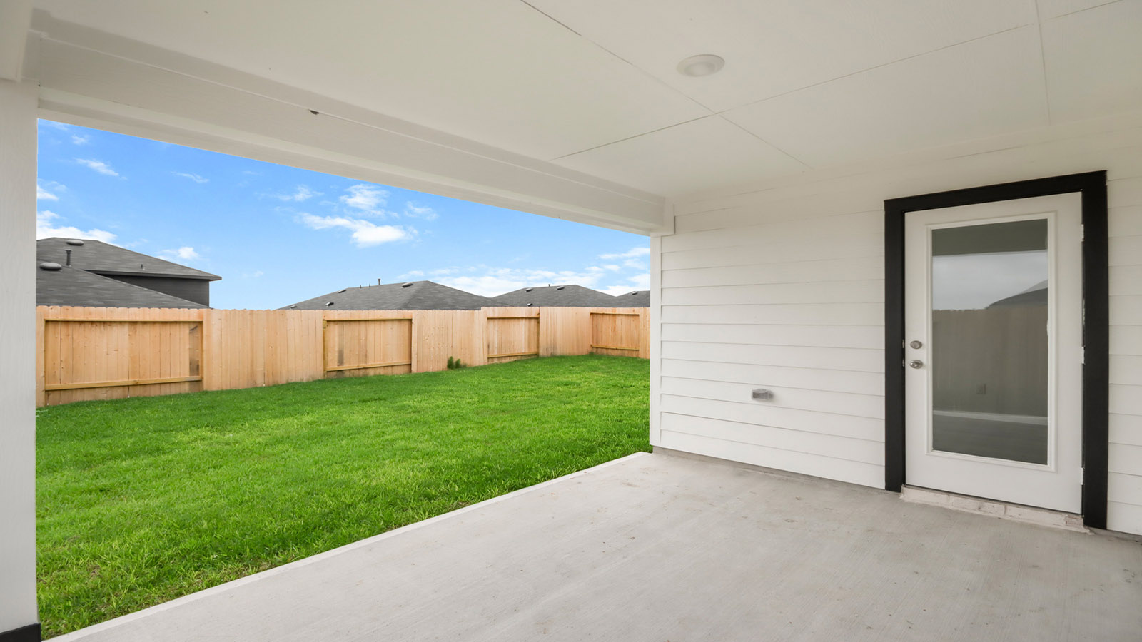 covered patio with jamies hardie siding and overhead lighting
