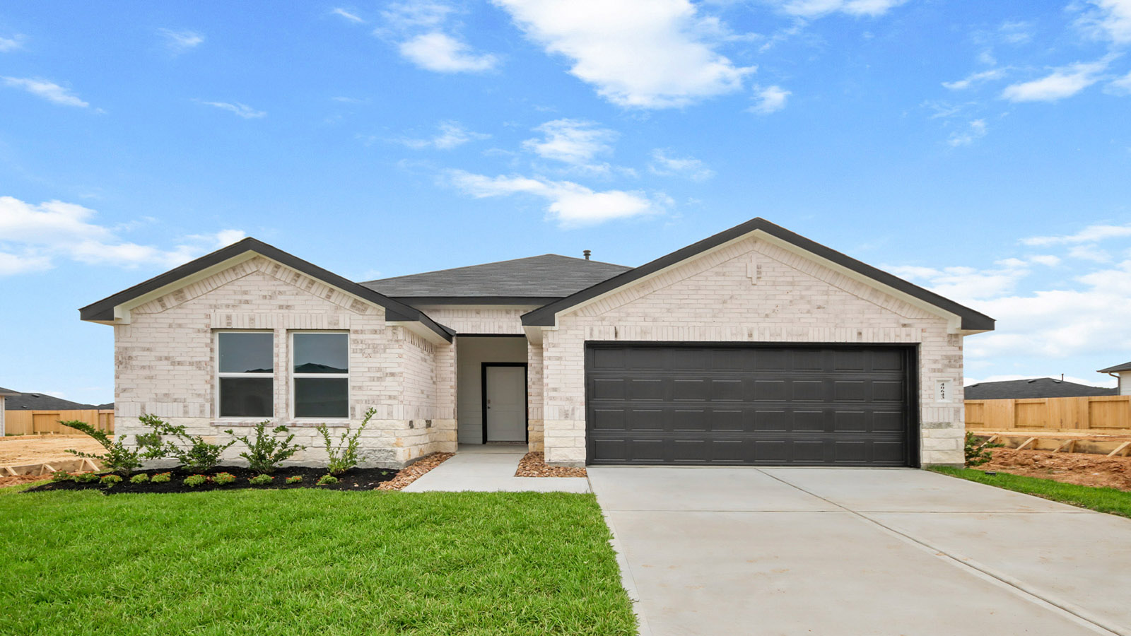 One story home with two car garage with brick and siding in Magnolia TX