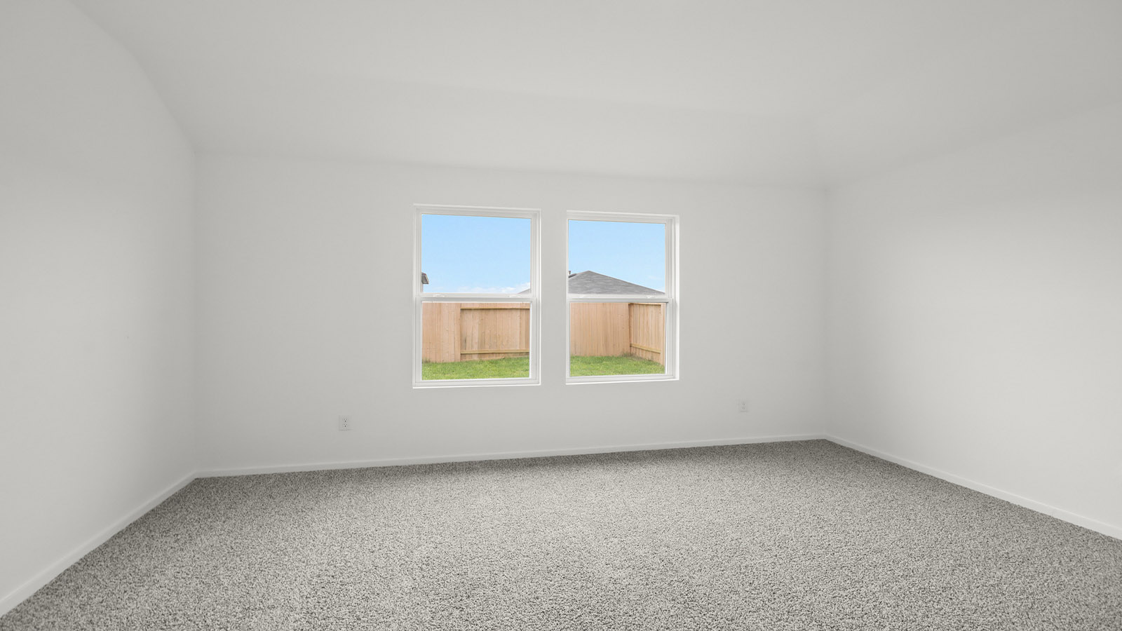 Large Primary bedroom with shag carpet flooring and bright window