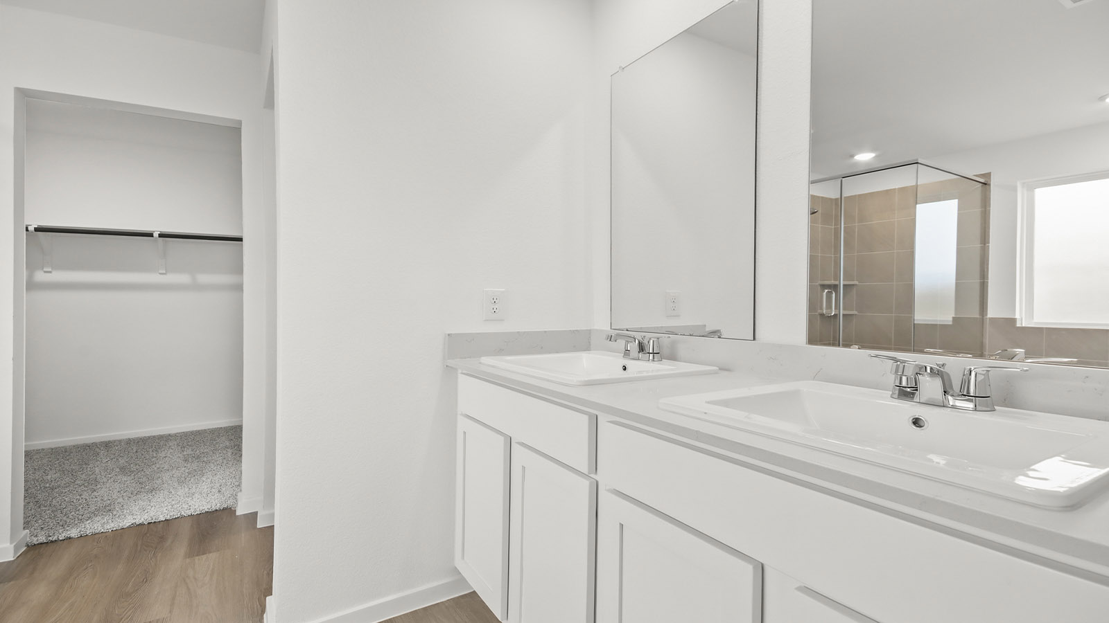 Primary bathroom with double sinks with quartz counter tops in Magnolia TX