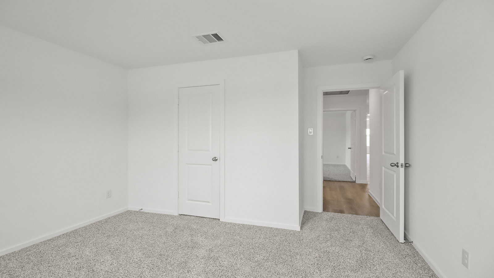 Secondary bedroom with shag carpet flooring and bright window