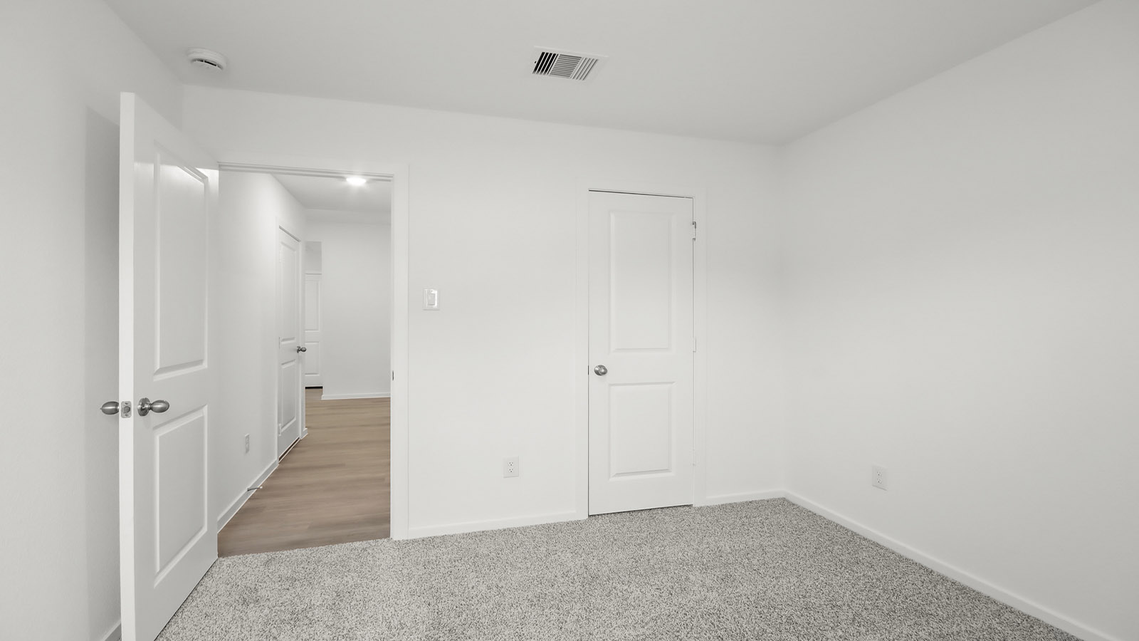 Secondary bedroom with shag carpet flooring and bright window