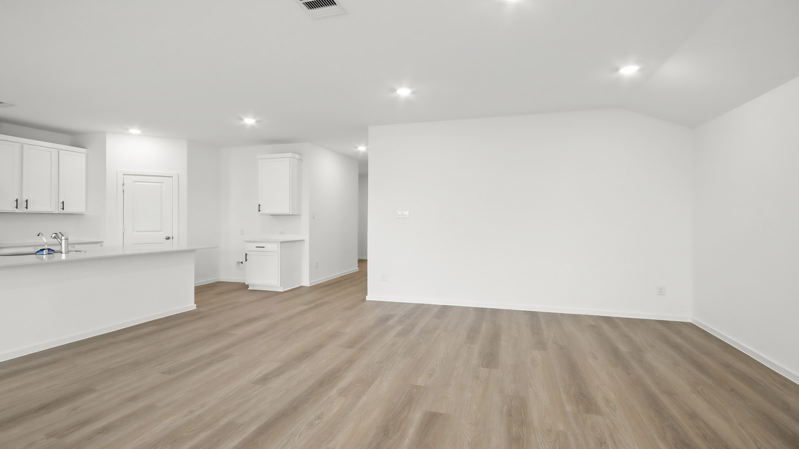 Spacious living area with vinyl flooring and bright windows in Magnolia TX