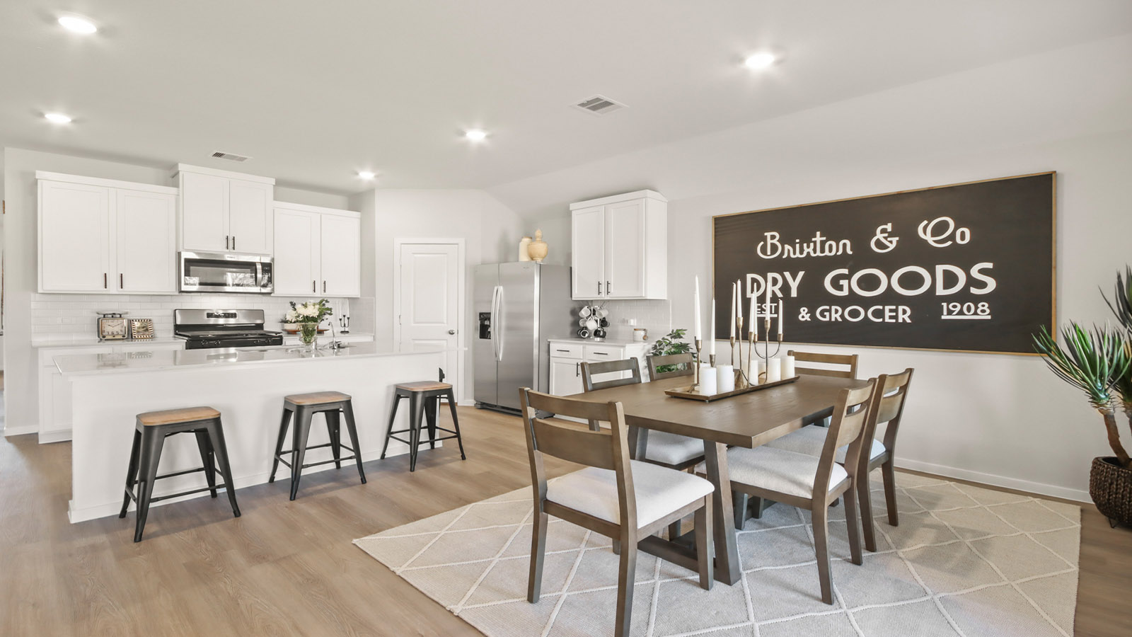 Kitchen with quartz countertops and marden hardware and an island and vinyl floor