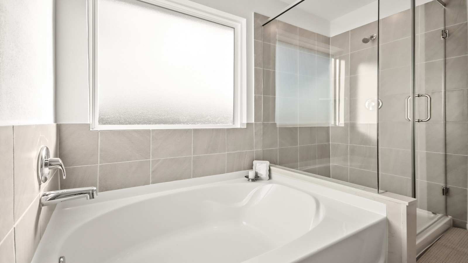 Primary bathroom with tile shower and semi-frameless glass and separate toilet room in Magnolia TX