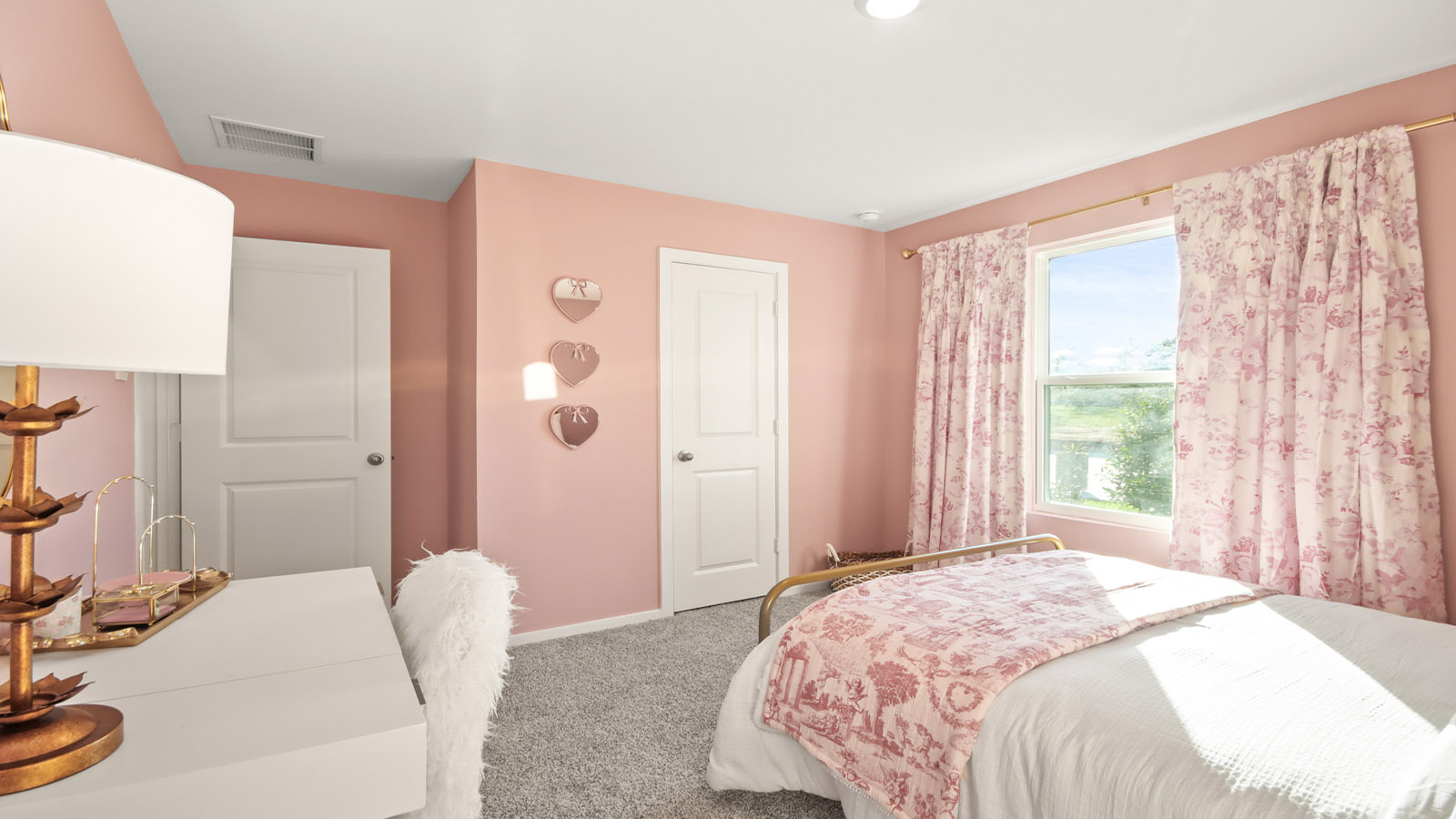 Secondary bedroom with shag carpet flooring and bright window