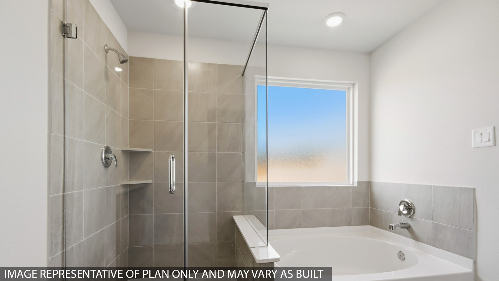 Primary bathroom with soaker tub and tile shower with semi frameless glass in Magnolia TX