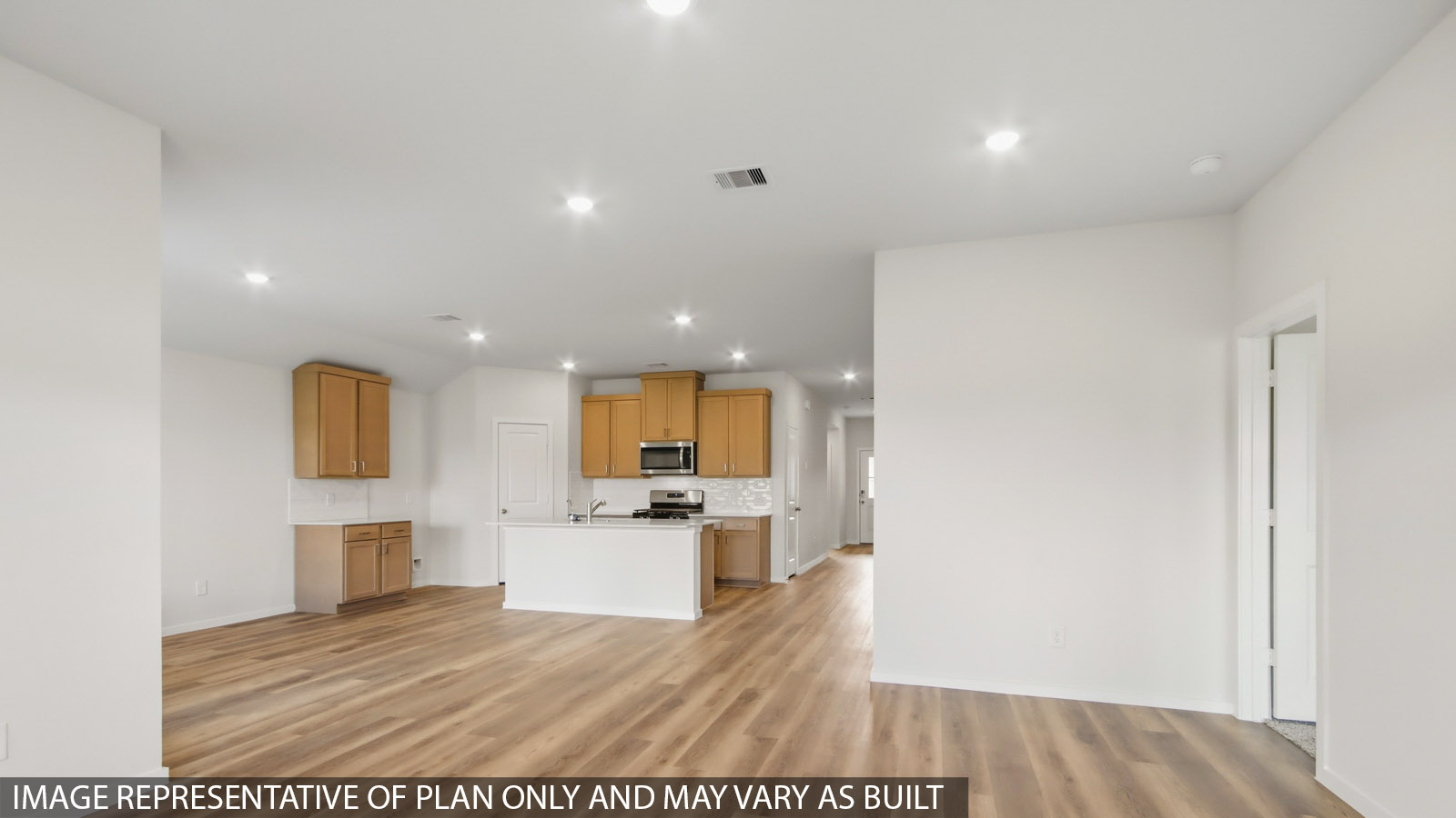 Kitchen with quartz countertops and marden hardware and an island and vinyl floor