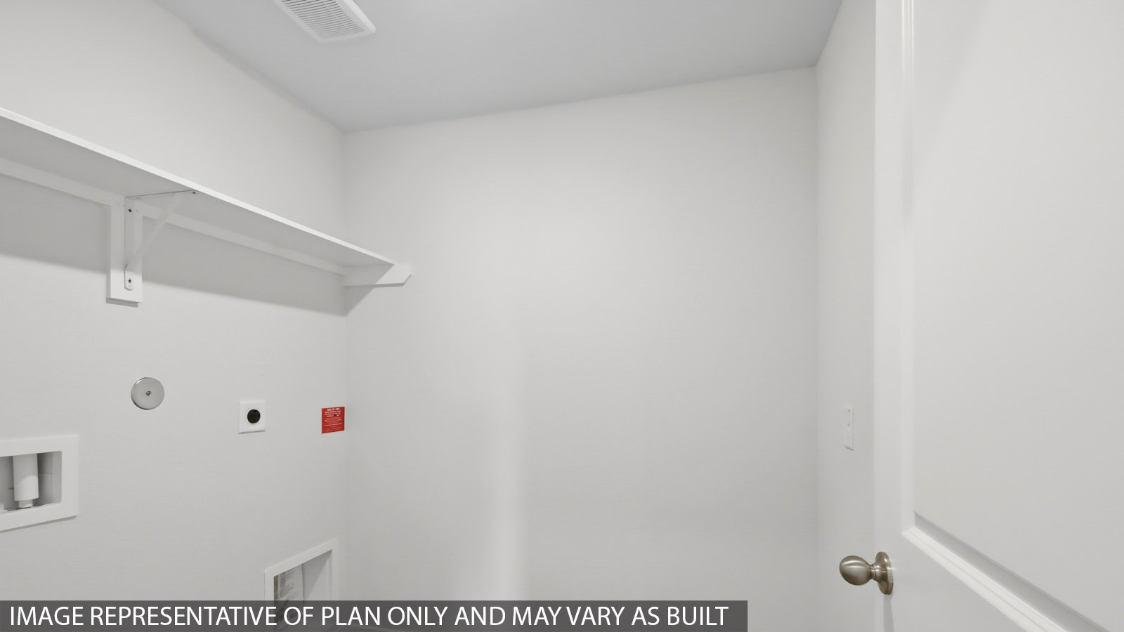 Utility room with storage located off the entry hallway and garage door