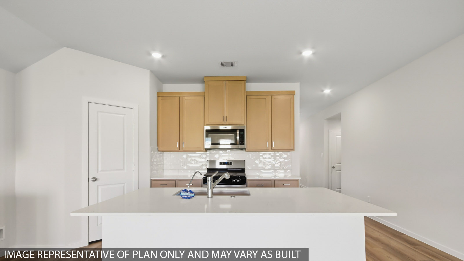 Kitchen with quartz countertops and marden hardware and an island and vinyl floor