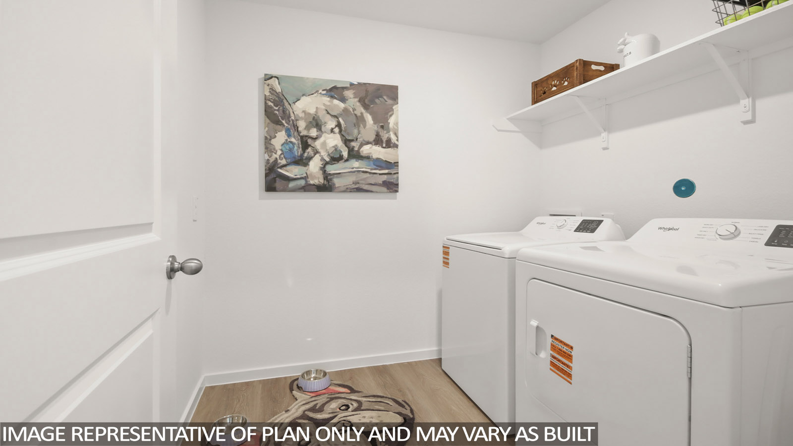 Utility room with storage located off the entry hallway and garage door