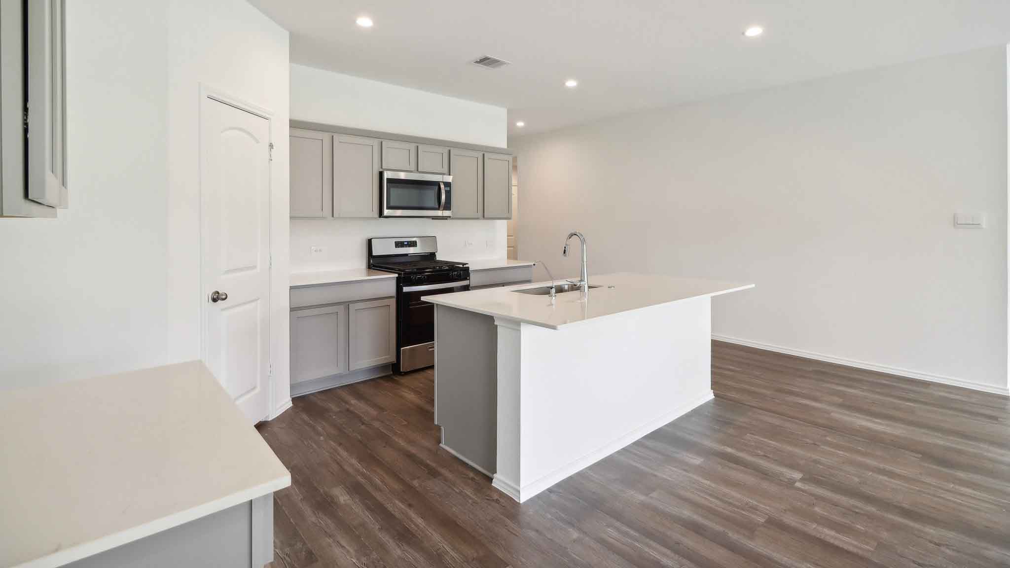 Kitchen with island and stainless-steel appliances.