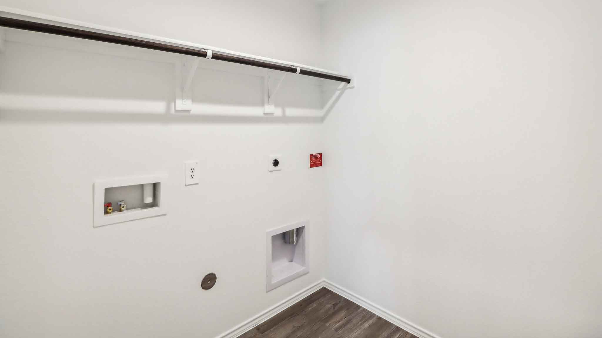 Utility room with vinyl flooring.