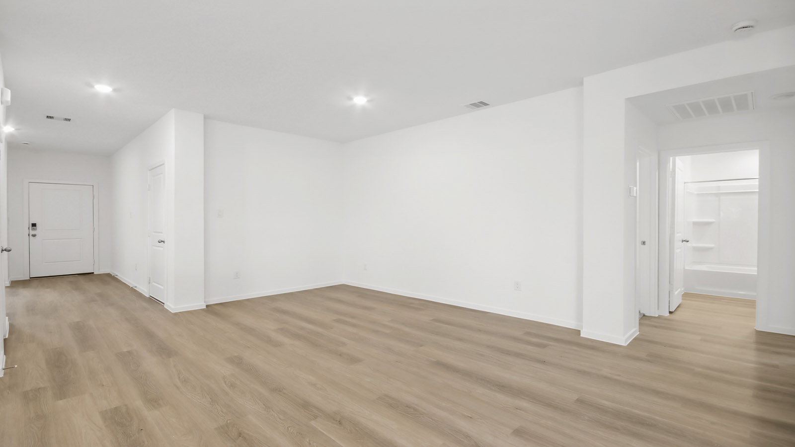 Spacious living area with vinyl flooring and bright windows in Magnolia TX