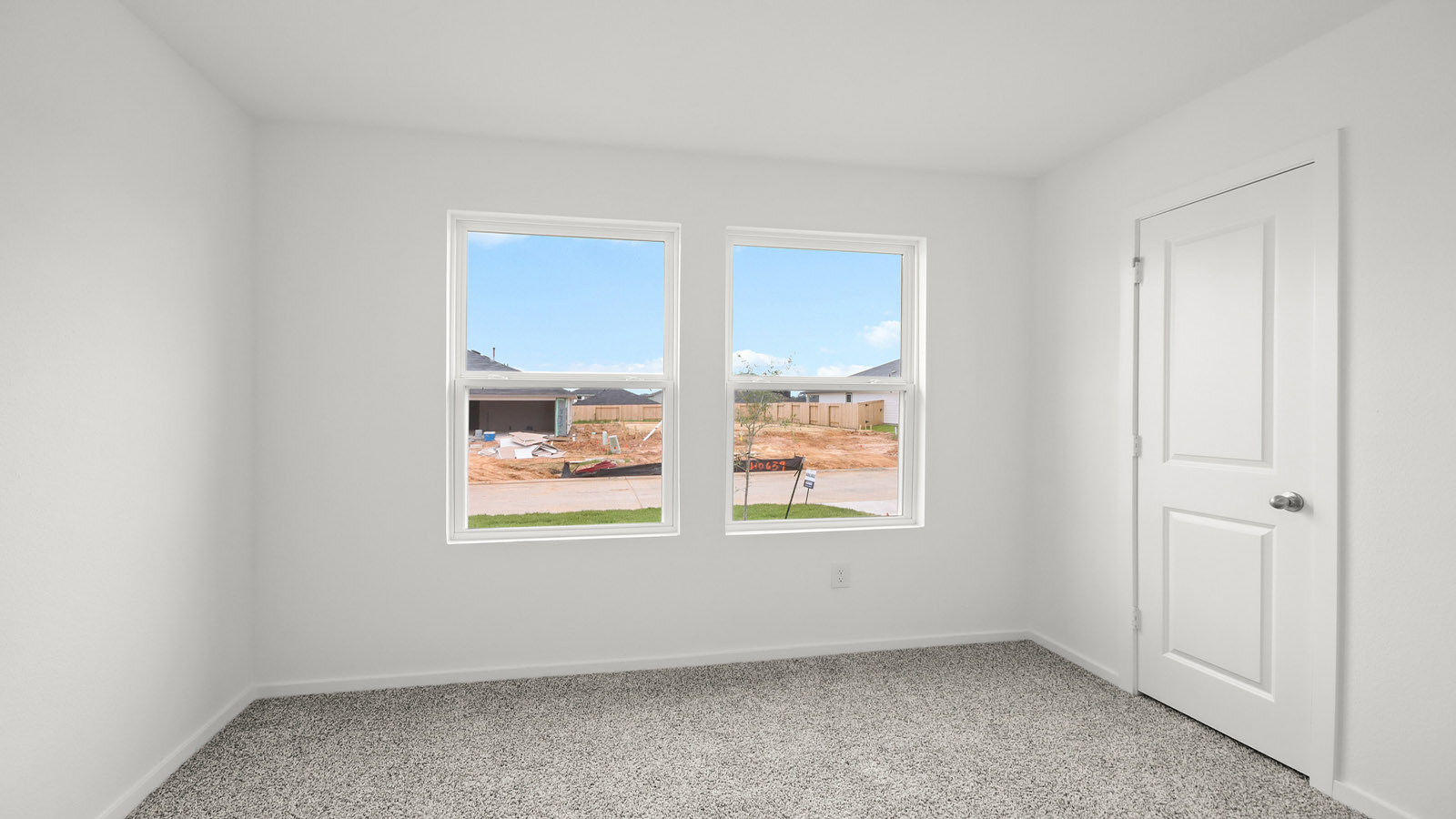 Secondary bedroom with shag carpet flooring and bright window