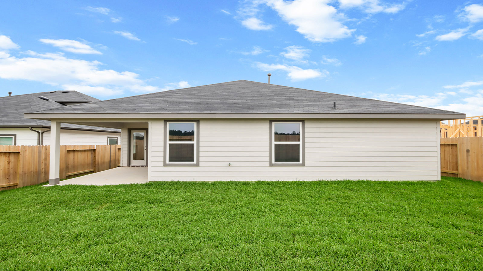 covered patio with jamies hardie siding and overhead lighting