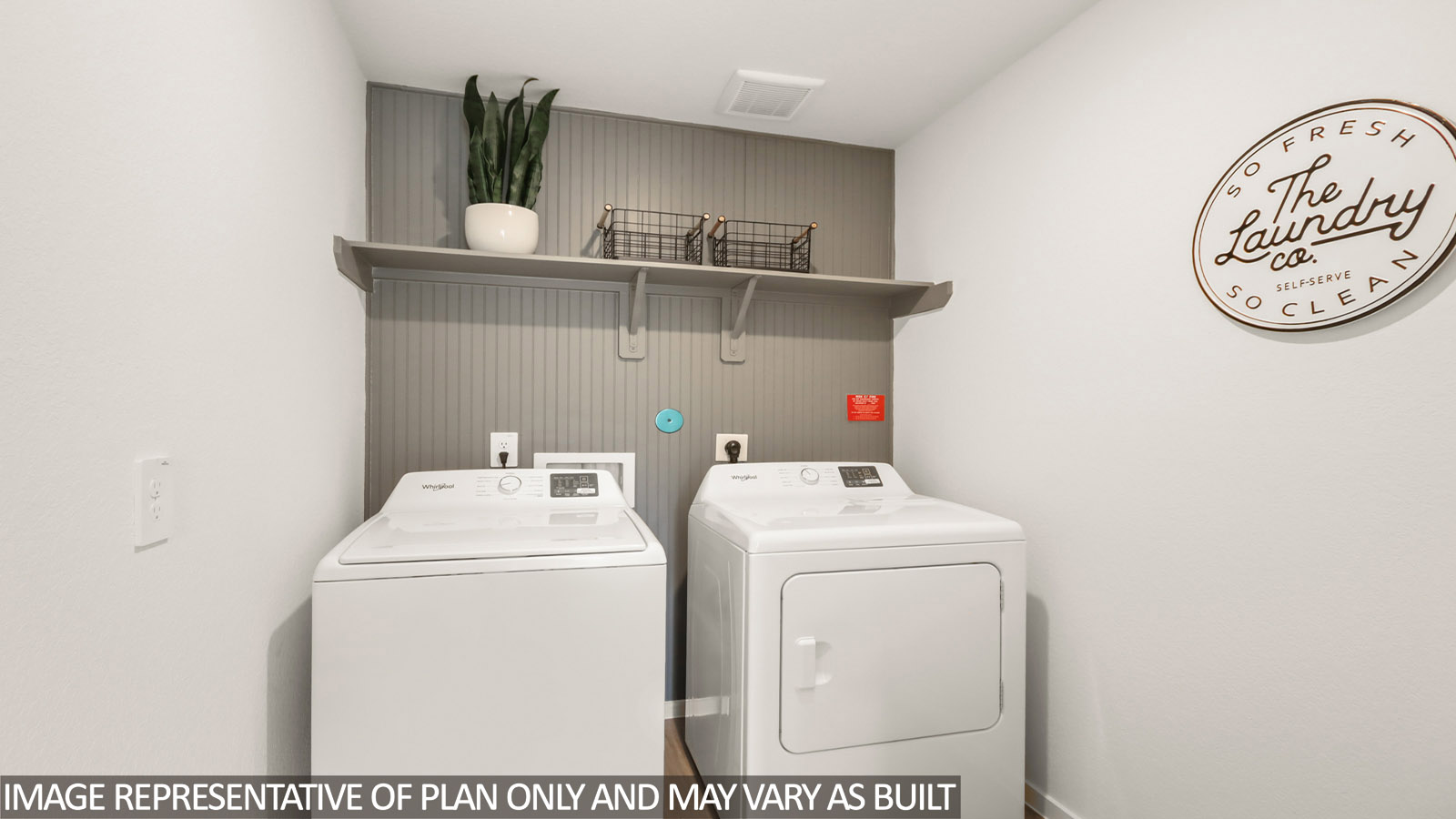 Utility room with storage located off the entry hallway and garage door