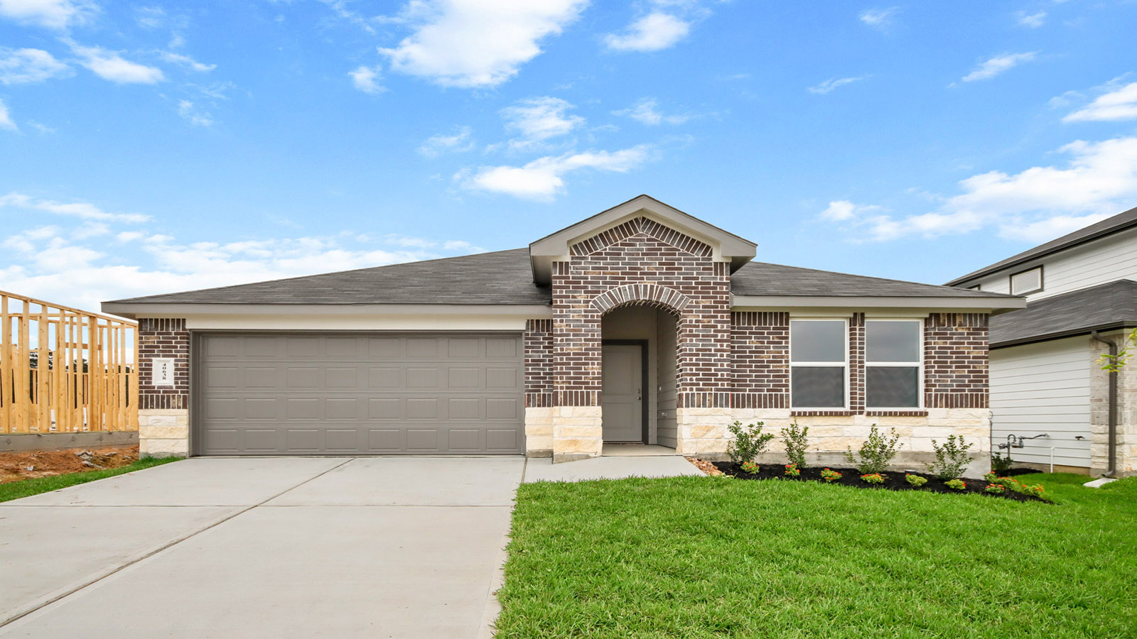 One story home with two car garage with brick and siding in Magnolia TX