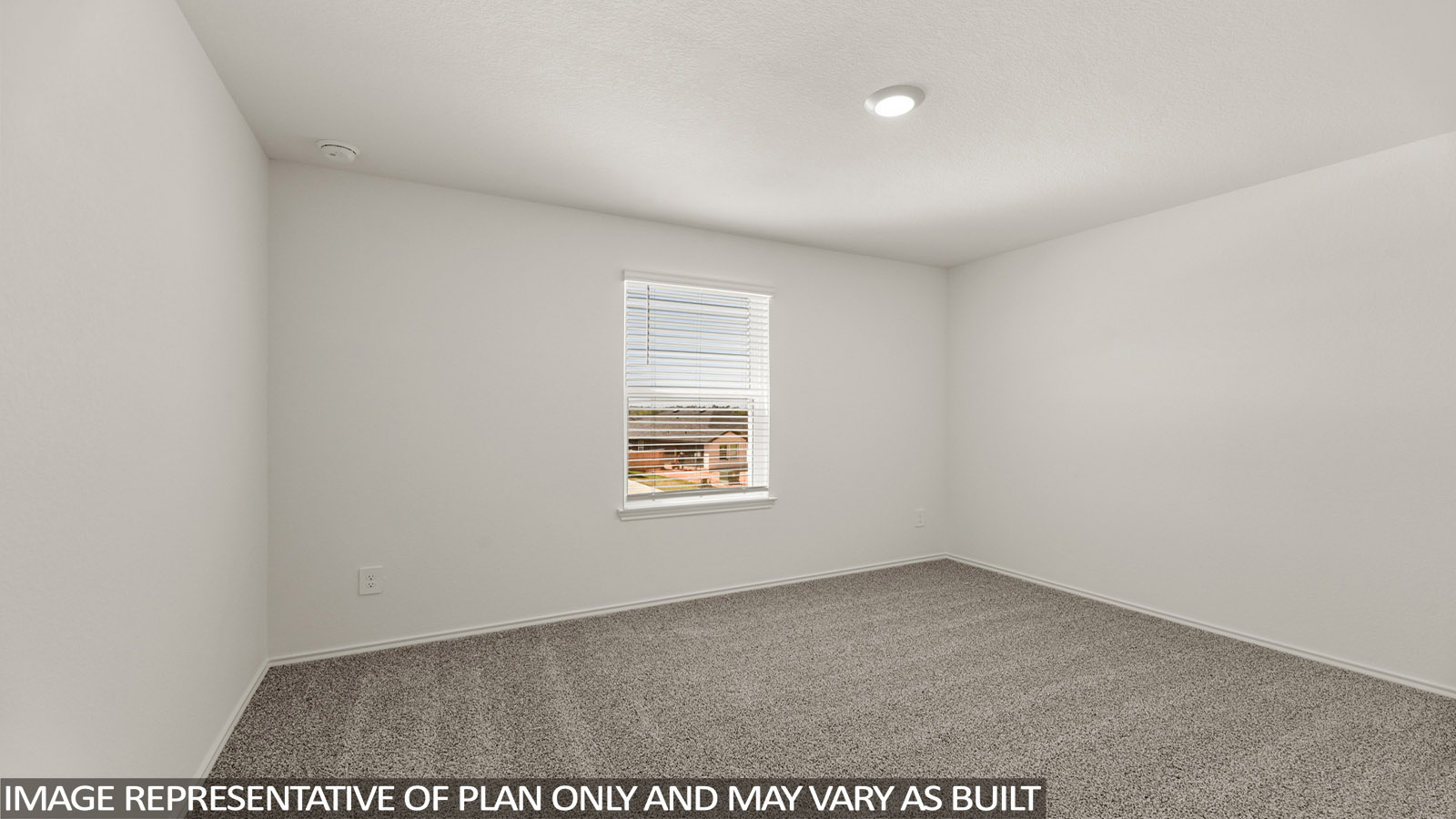 Secondary bedroom with carpet flooring