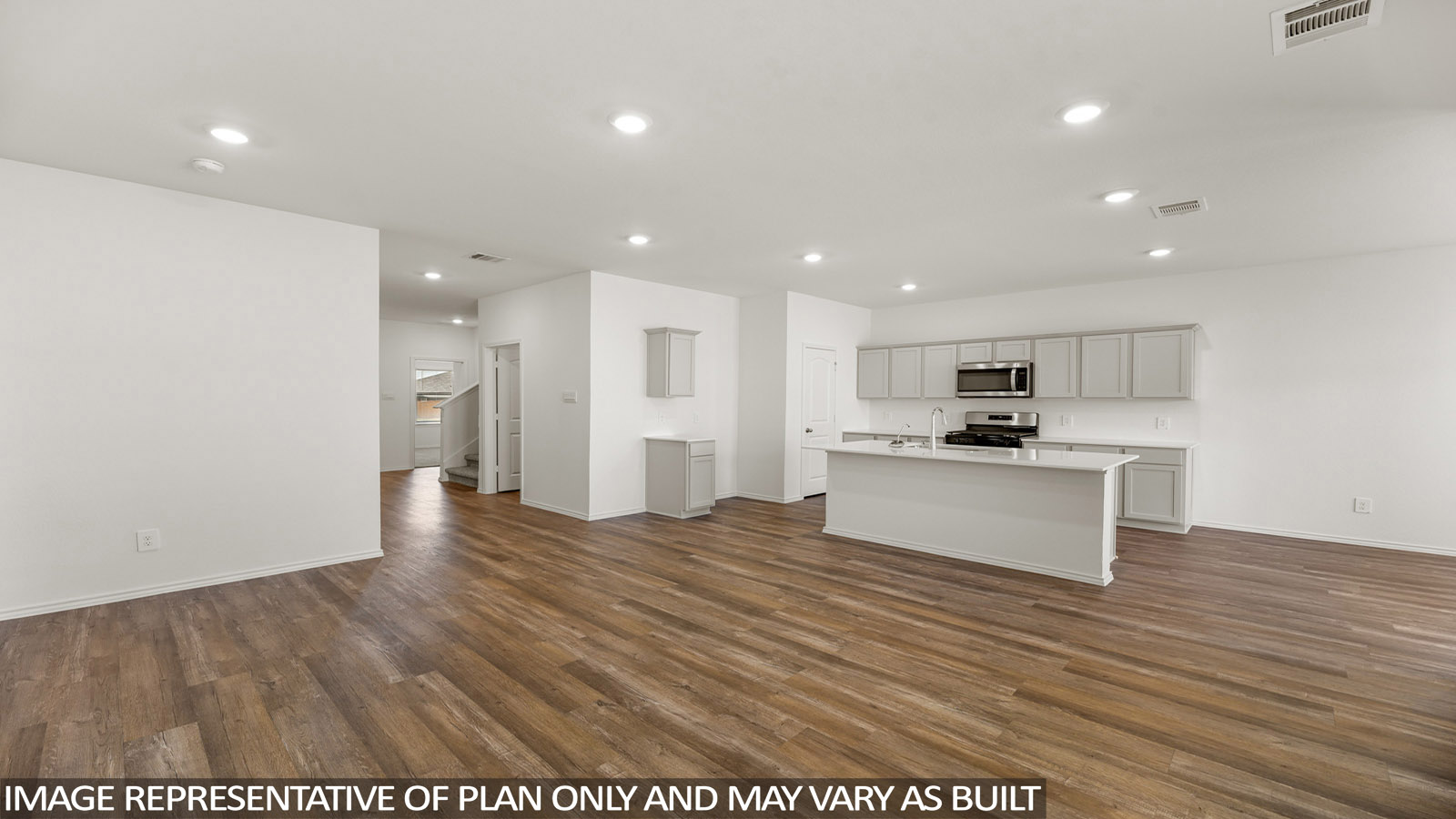 Spacious living area with vinyl flooring