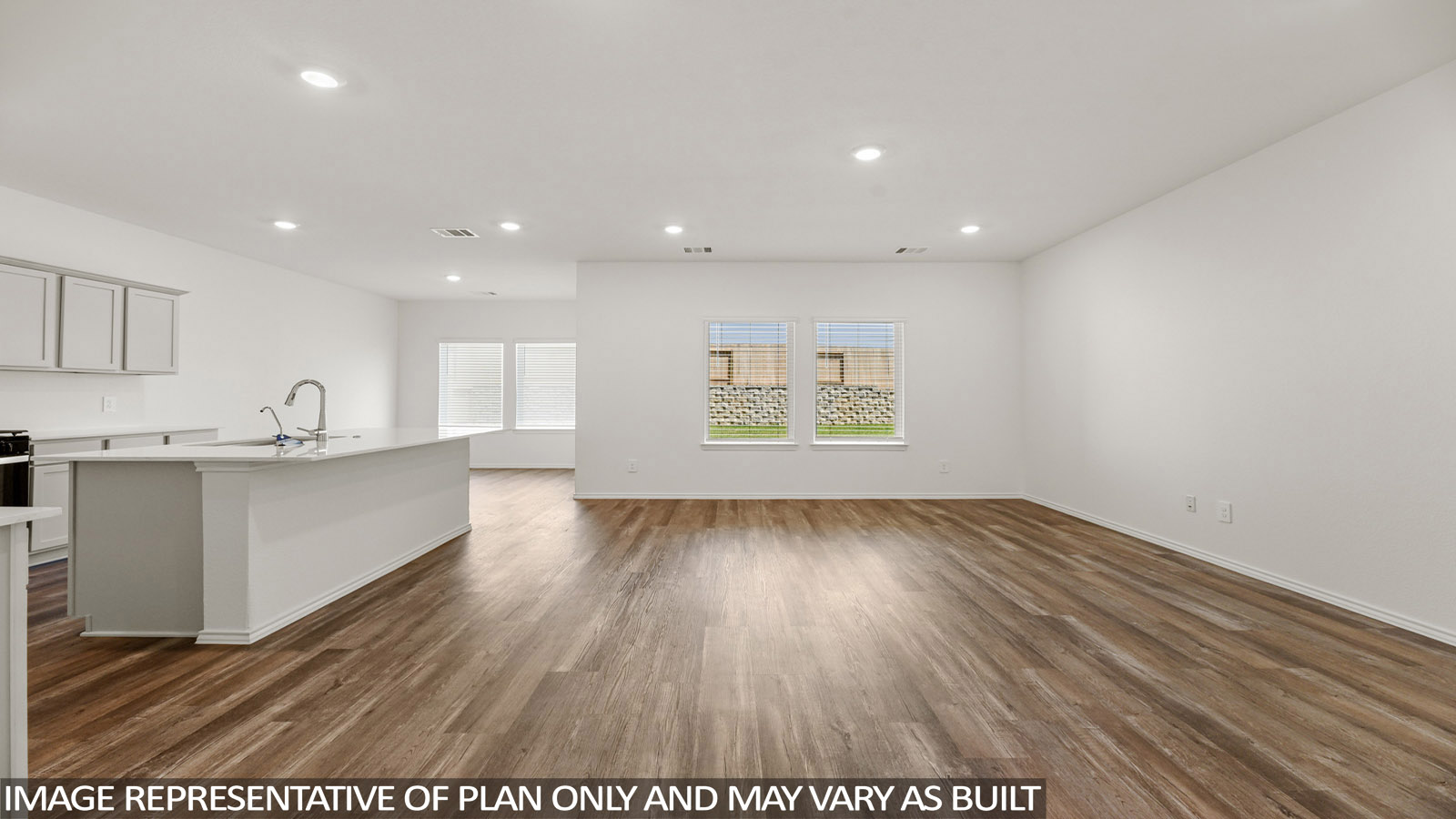 Spacious living area with vinyl flooring