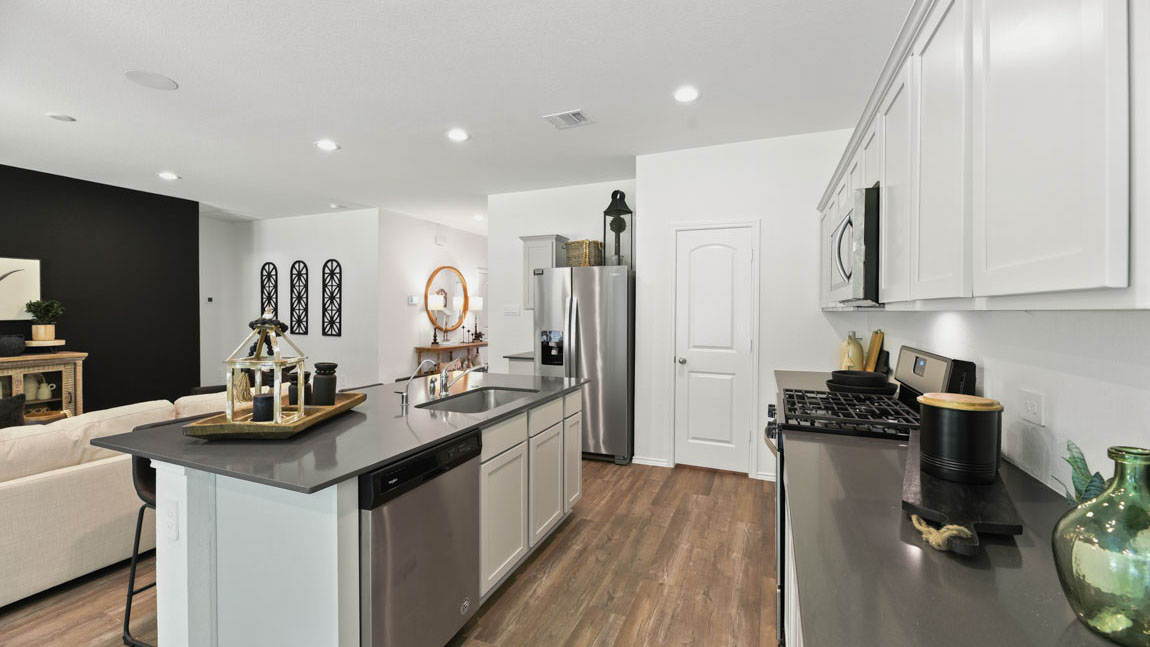 Kitchen with an island and vinyl floor